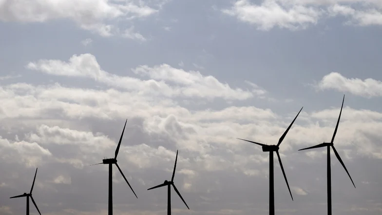 Man sieht Windräder.