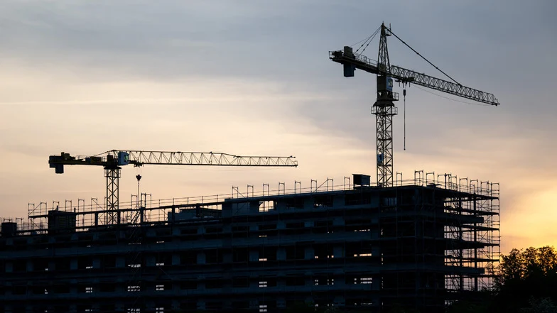 Man sieht eine Baustelle bei Sonnenaufgang.